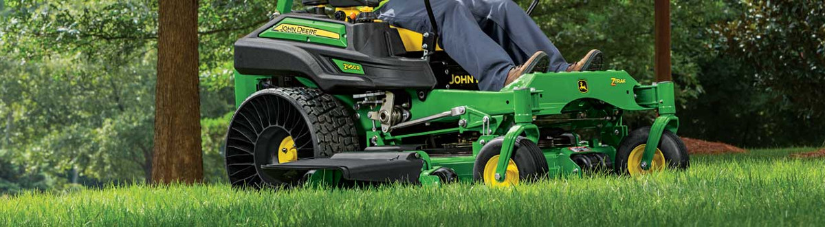 Man riding a 2018 John Deere Lawn Mower mowing grass